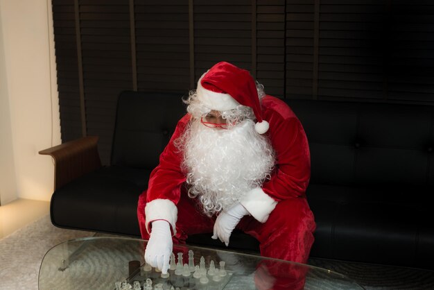 Papai Noel solitário jogando xadrez sozinho com tristeza