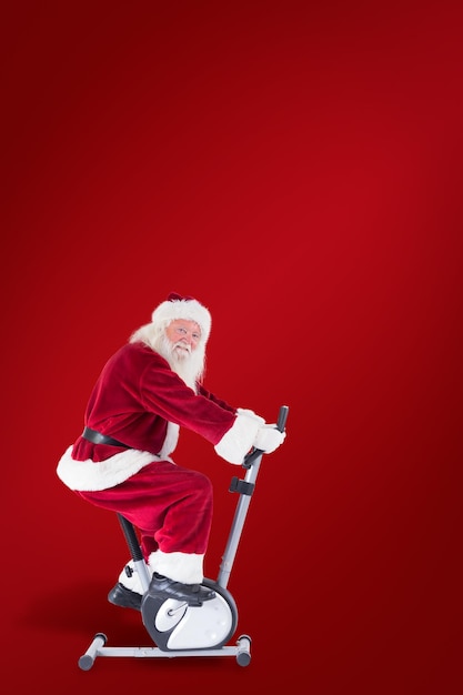 Papai Noel usa um treinador doméstico contra um fundo vermelho