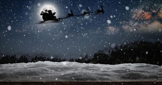 Papai Noel voa na véspera de Natal no céu noturno com neve