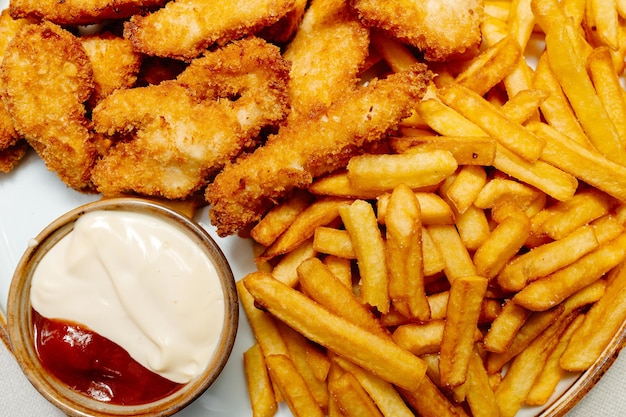 Papas fritas con carne empanizada y salsa