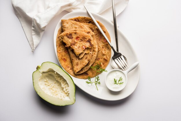 Papaya cruda Paratha o Papita ke Parathe elaborado con Papaya, harina de trigo, semillas de comino y jengibre. Receta popular de comida india servida caliente con cuajada. enfoque selectivo