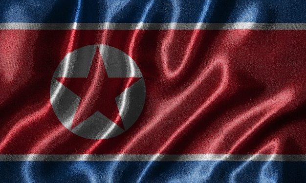 Papel de parede pela bandeira da Coreia do Norte e agitando bandeira por tecido