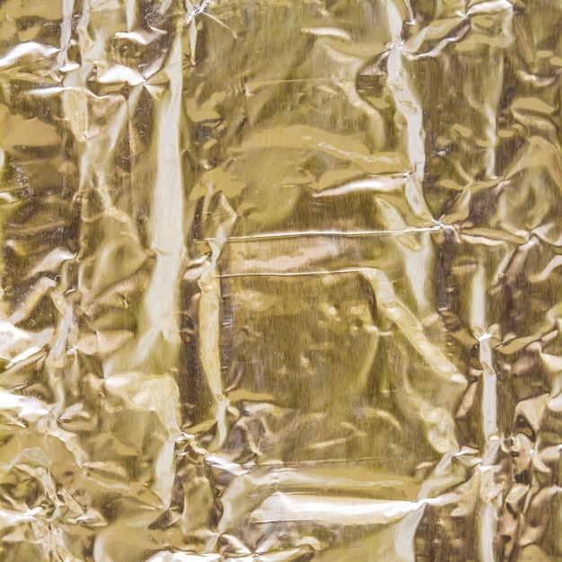 Foto papel dourado vincado e dobrado para fornecer um plano de fundo texturizado