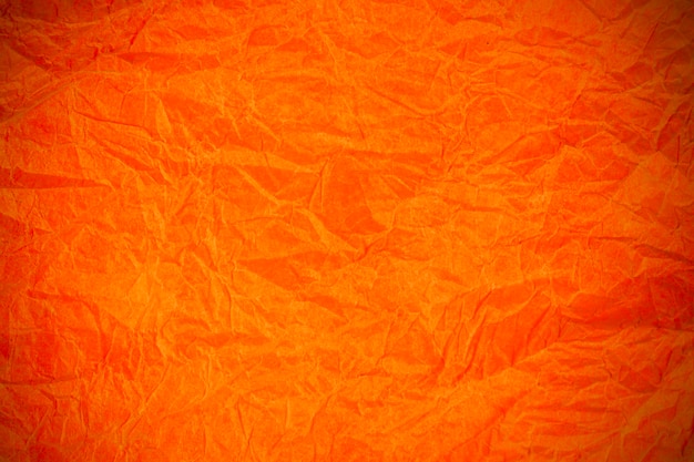 Papel laranja vintage amarrotado com textura de fundo obsoleto.