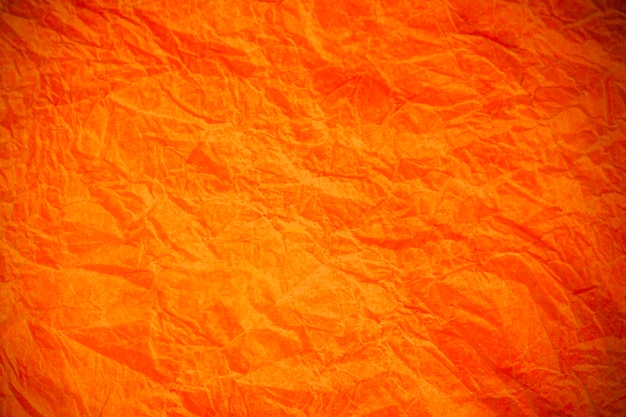 Papel laranja vintage amarrotado com textura de fundo obsoleto.