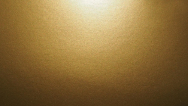 Papel marrom amarelo com uma iluminação de brilho metálico brilha de cima Fundo abstrato com gradiente Copiar espaço Textura e saliências na superfície O brilho de pontos individuais