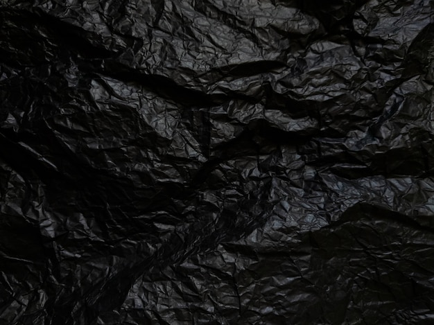 Papel negro arrugado con textura Fondo texturizado negro oscuro