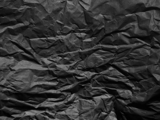 Papel preto amassado com textura Fundo texturizado preto escuro