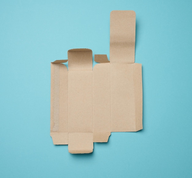 Foto papel protector de debajo de una caja con una plantilla de perfume de cartón ondulado blanco