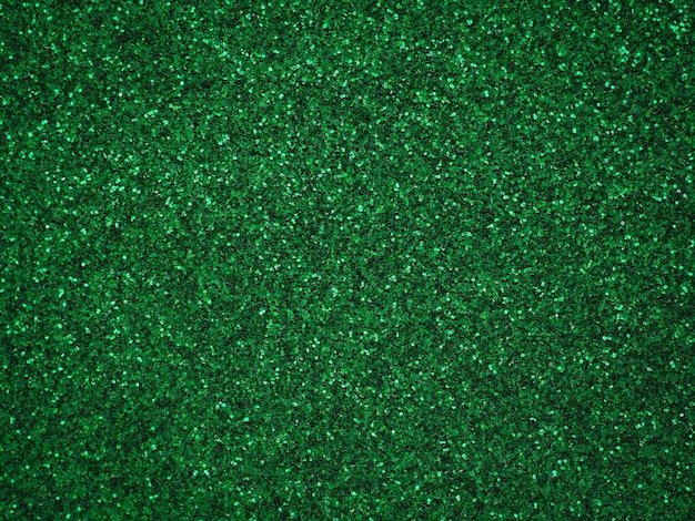 Un papel verde brillante, un brillo plateado, un bokeh ligero, un patrón de textura abstracta y un papel tapiz brillante.