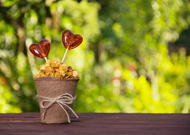 Pappbecher mit Karamellpopcorn und Süßigkeiten