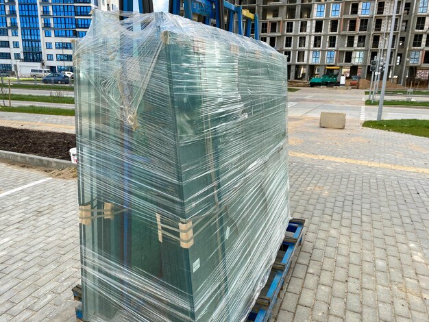 Foto un paquete grande de vidrio para ventanas de doble acristalamiento envuelto con película estirable