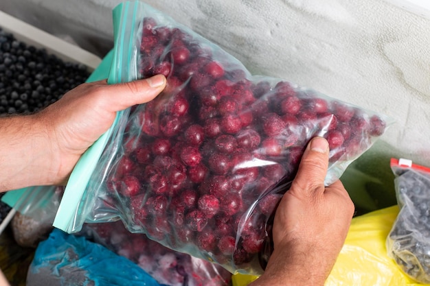 Foto paquetes con cerezas congeladas en el congelador alimentos congelados