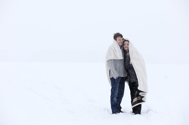 Un par de amantes en una fecha tarde de invierno en una ventisca de nieve