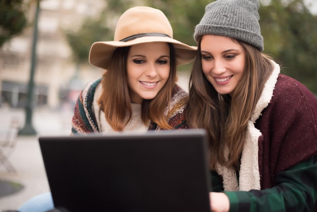 Un par de chicas viendo videos graciosos en una laptop