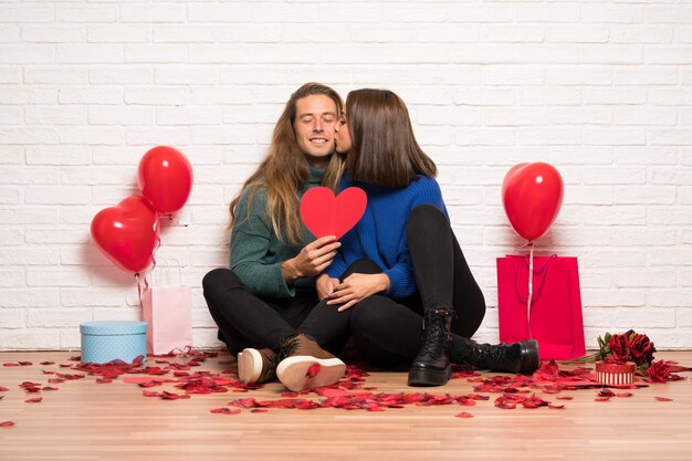 Par, dia valentine, segurando, um, coração, símbolo, e, beijando