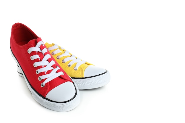 Par de zapatillas rojas y amarillas aislado sobre fondo blanco.