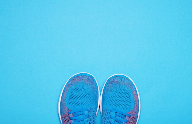 Un par de zapatos deportivos azules sobre fondo azul.