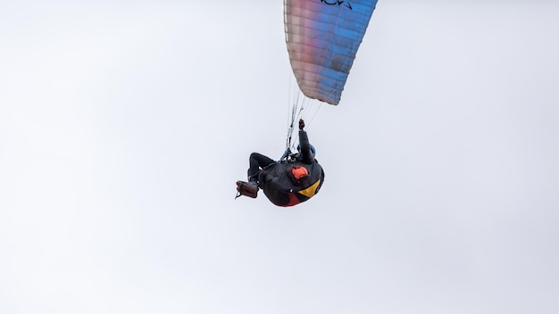 Pára-quedismo de esportes radicais de paraquedismo com um pára-quedas desdobrado O esportista voando em um parapente