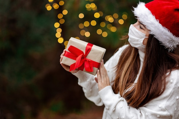 Parabéns máscara de Natal com máscara médica dando caixa de presente