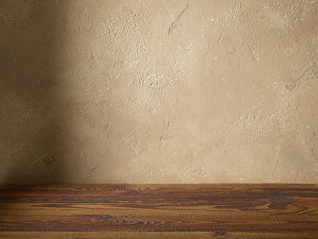 Pared de color beige y fondo de mesa de madera marrón