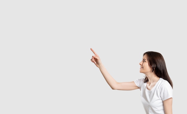 Foto pared comercial divertida mujer apuntando hacia arriba