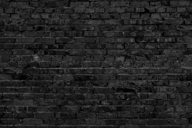 Foto pared del edificio de ladrillo negro. fondo