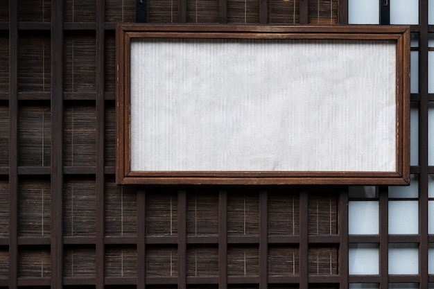 Pared y estera de madera japonesas del viejo estilo detrás con una caja del viejo estilo de etiqueta de la muestra del Libro Blanco.