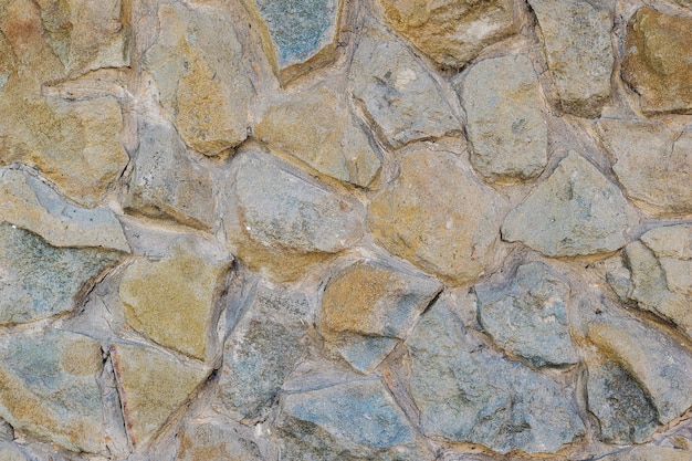 Foto pared de fondo de las grandes piedras hermosas puestas en el mortero.