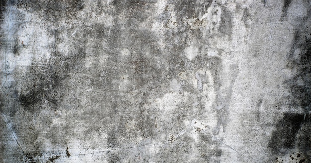 Foto una pared gris con una mancha negra y una mancha blanca.