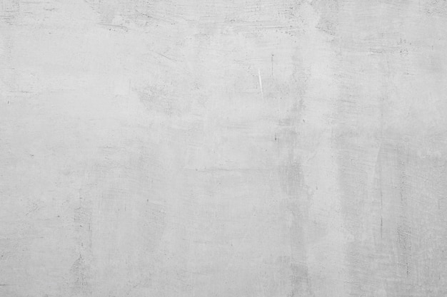 una pared de hormigón gris con un fondo blanco que dice
