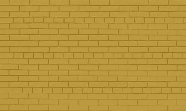 Foto una pared de ladrillo amarillo con un color marrón oscuro.