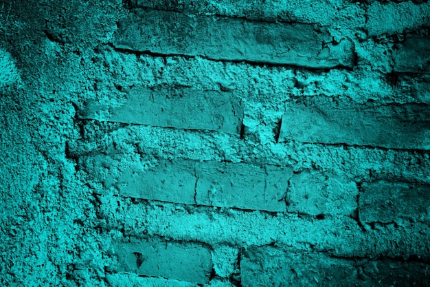 Una pared de ladrillo azul con un fondo de ladrillo verde.