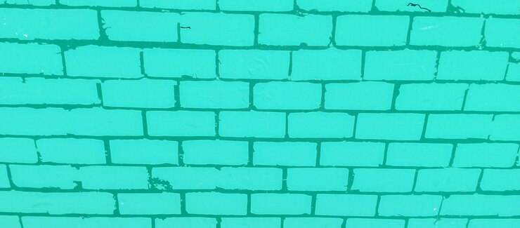 Foto una pared de ladrillo con un ladrillo verde que dice ladrillo en él
