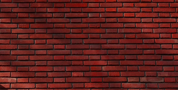 Una pared de ladrillo rojo con un fondo oscuro.