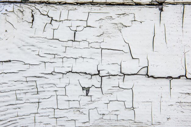 Foto pared de madera con pintura blanca vieja agrietada