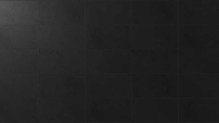 Foto pared oscura de textura de hormigón con un fondo oscuro y una fuente de luz