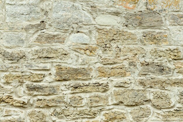 Pared de piedra amarilla y beige sólida