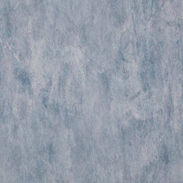 Una pared de textura gris con un fondo azul.