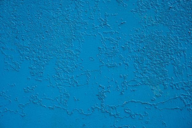 Foto pared vieja pintada con pintura azul que se agrieta de vez en cuando