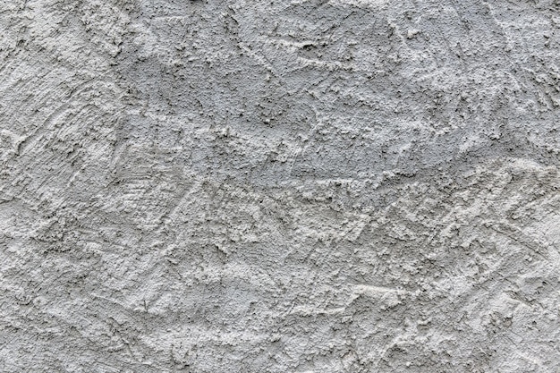 Una pared de yeso blanco con una textura áspera.