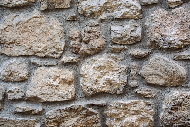 Parede de pedra de grandes pedras. Textura rústica de parede de pedra cinza. parte de uma parede de pedra