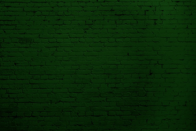 Foto parede de tijolos verdes. design de interiores do loft. pintura verde de fachada. fundo arquitetônico.