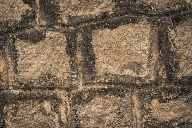 Parede do templo antigo retangular cortado mármore granito tijolo superfície real pedra com cimento padrão cor cinza textura rústica fundo design website sombrio escuro sombrio sombrio humor mais tom em estoque