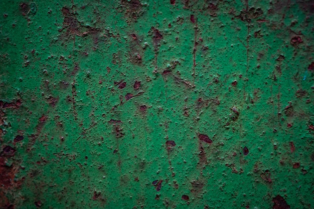 Parede oxidada de metal verde enferrujado com corrosão e arranhões, textura de aço antigo