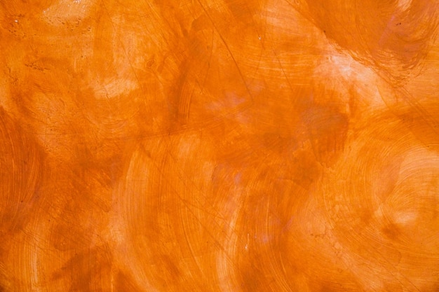 Parede texturizada pintada com fundo escovado Abstrato cor de óleo laranja