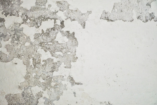 Paredes de cemento blanco, pintura pelada. Pelar la pared de la pintura de la casa blanca con mancha negra.