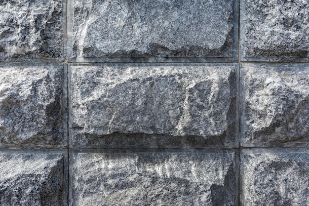 Paredes de mampostería de primer plano de granito gris. Textura y patrón de piedra natural.