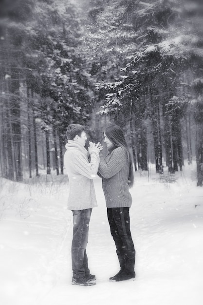 Una pareja amorosa en un paseo invernal. Hombre y mujer en una cita en el parque en invierno. Amigos en el parque de invierno