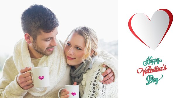 Pareja amorosa en ropa de invierno con tazas de café contra la ventana contra el feliz día de san valentín